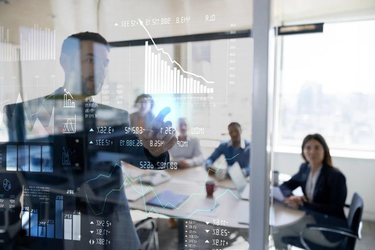 Business people in bright meeting room with charts and graphs
