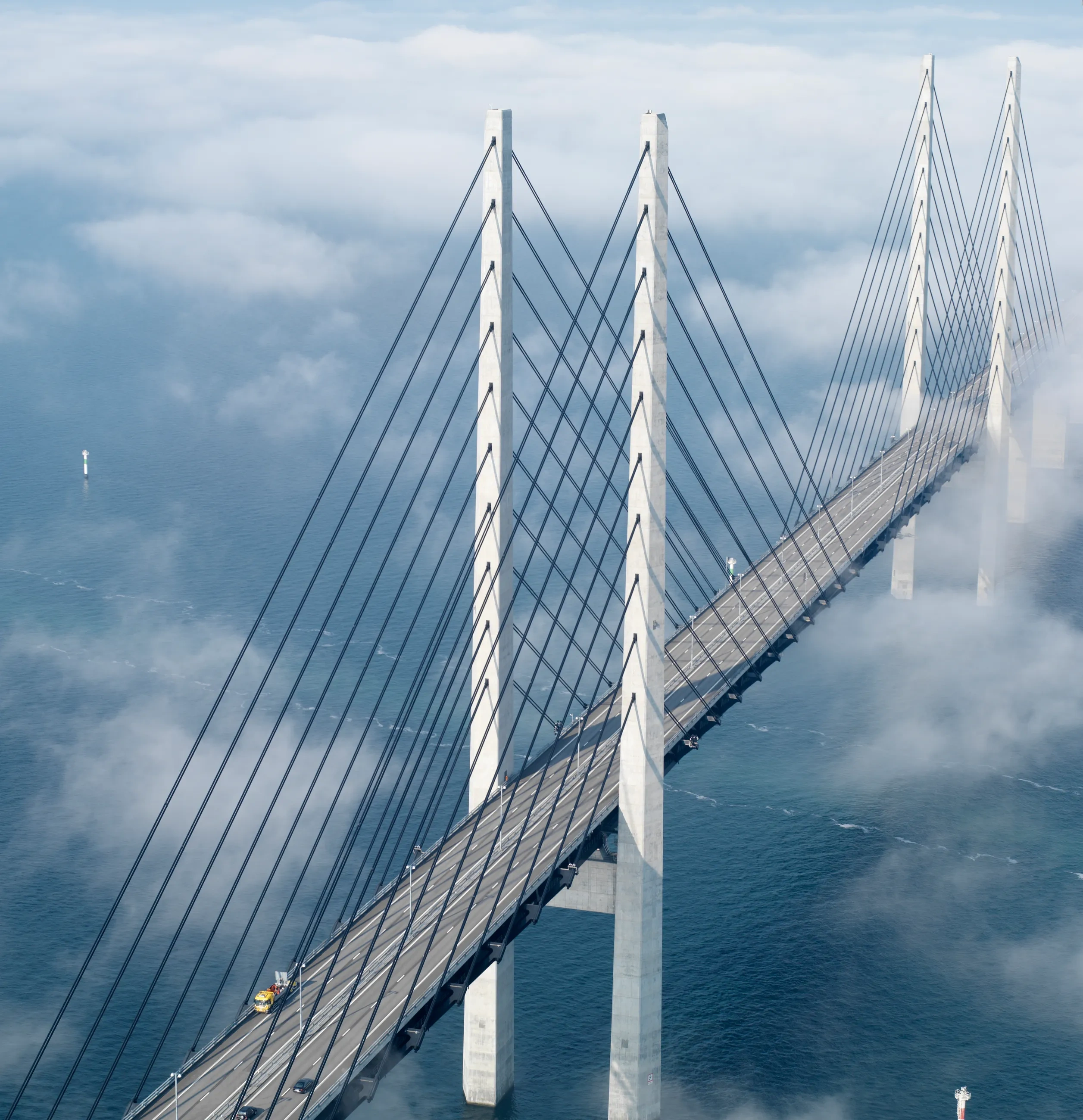 two people in silhouette climb a mountain at sunrise