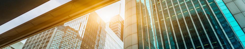 glass city buildings from beneath a bridge