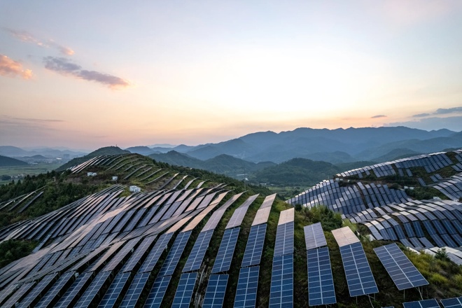 a mountain view with a field full of solar panels