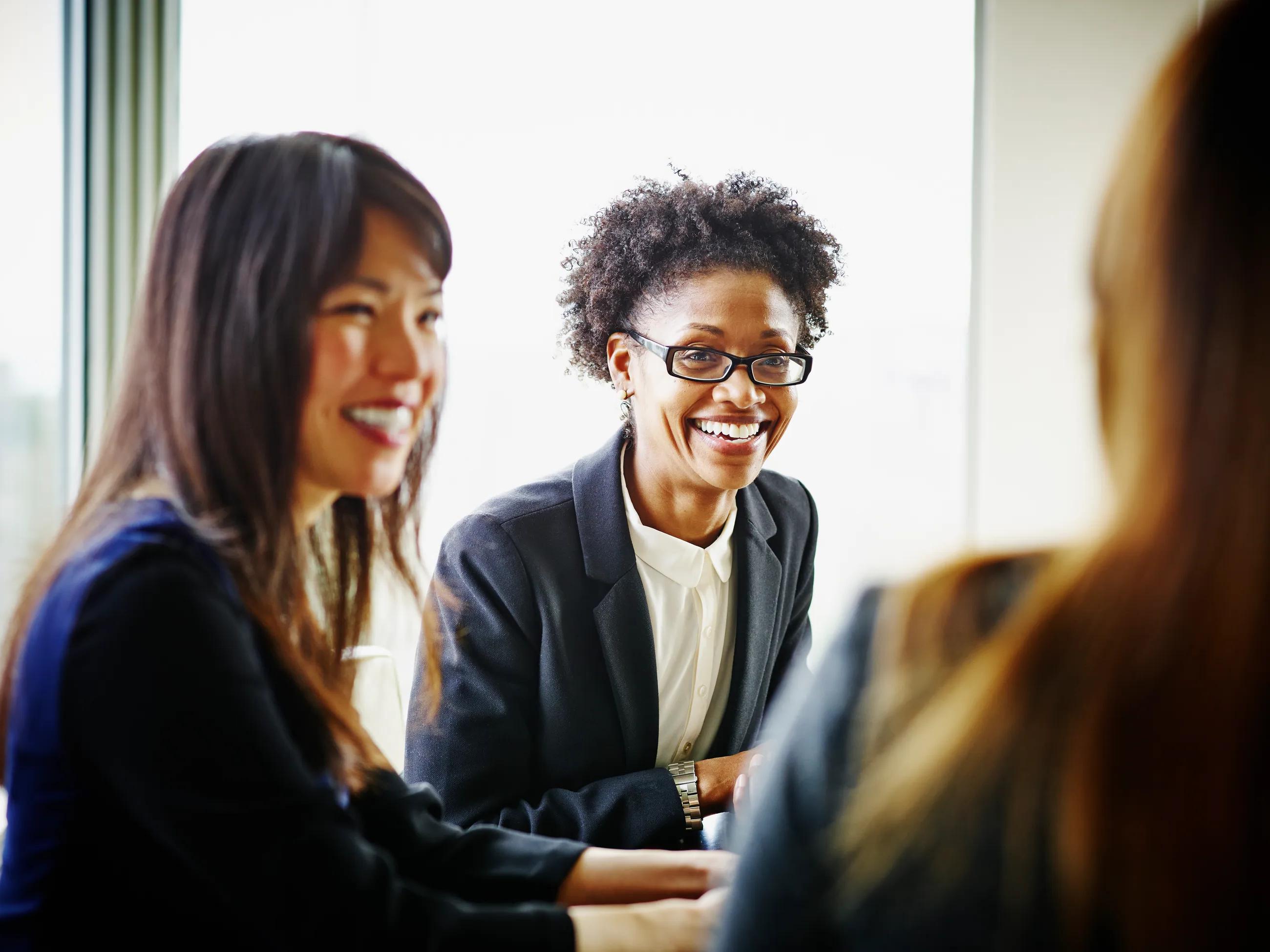 People smiling in meeting | Diversity, Equity and Inclusion