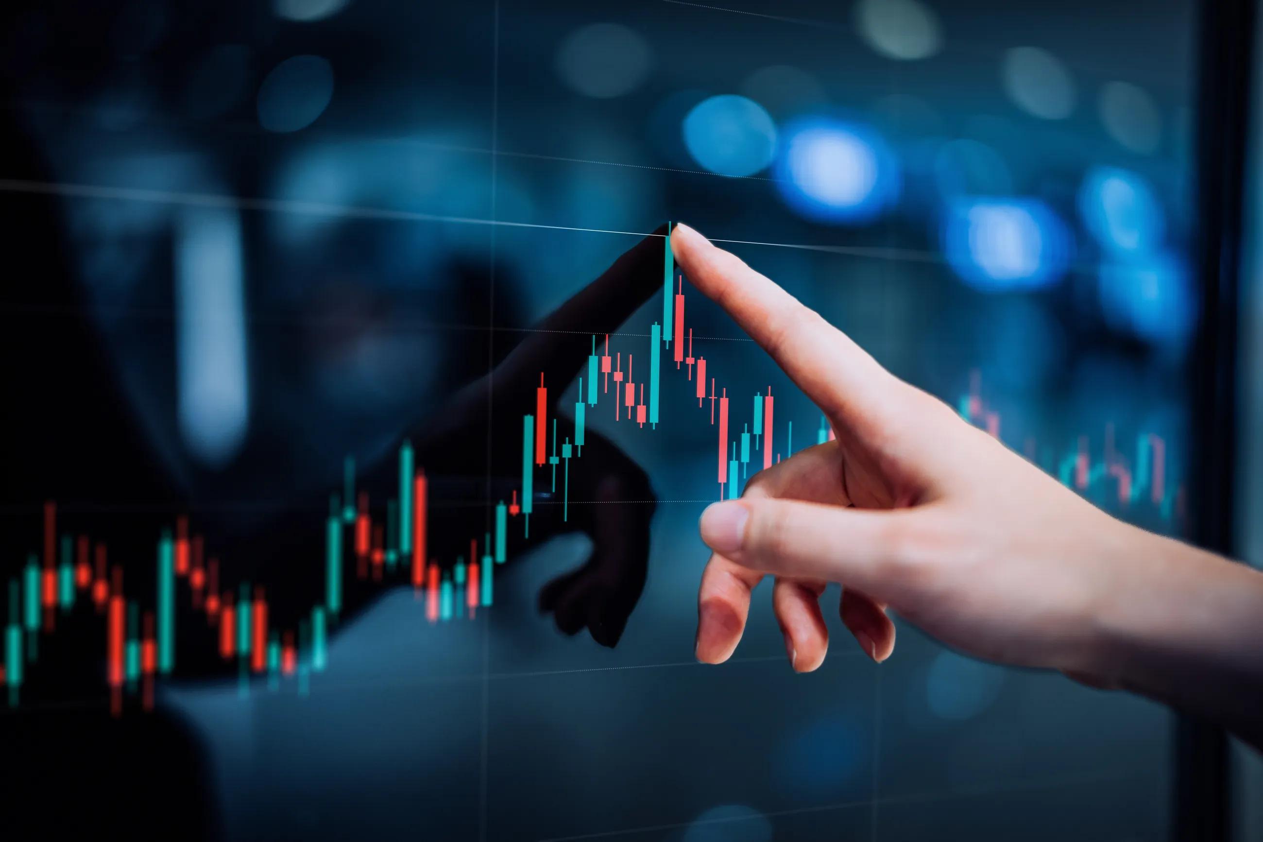 person pointing at graph