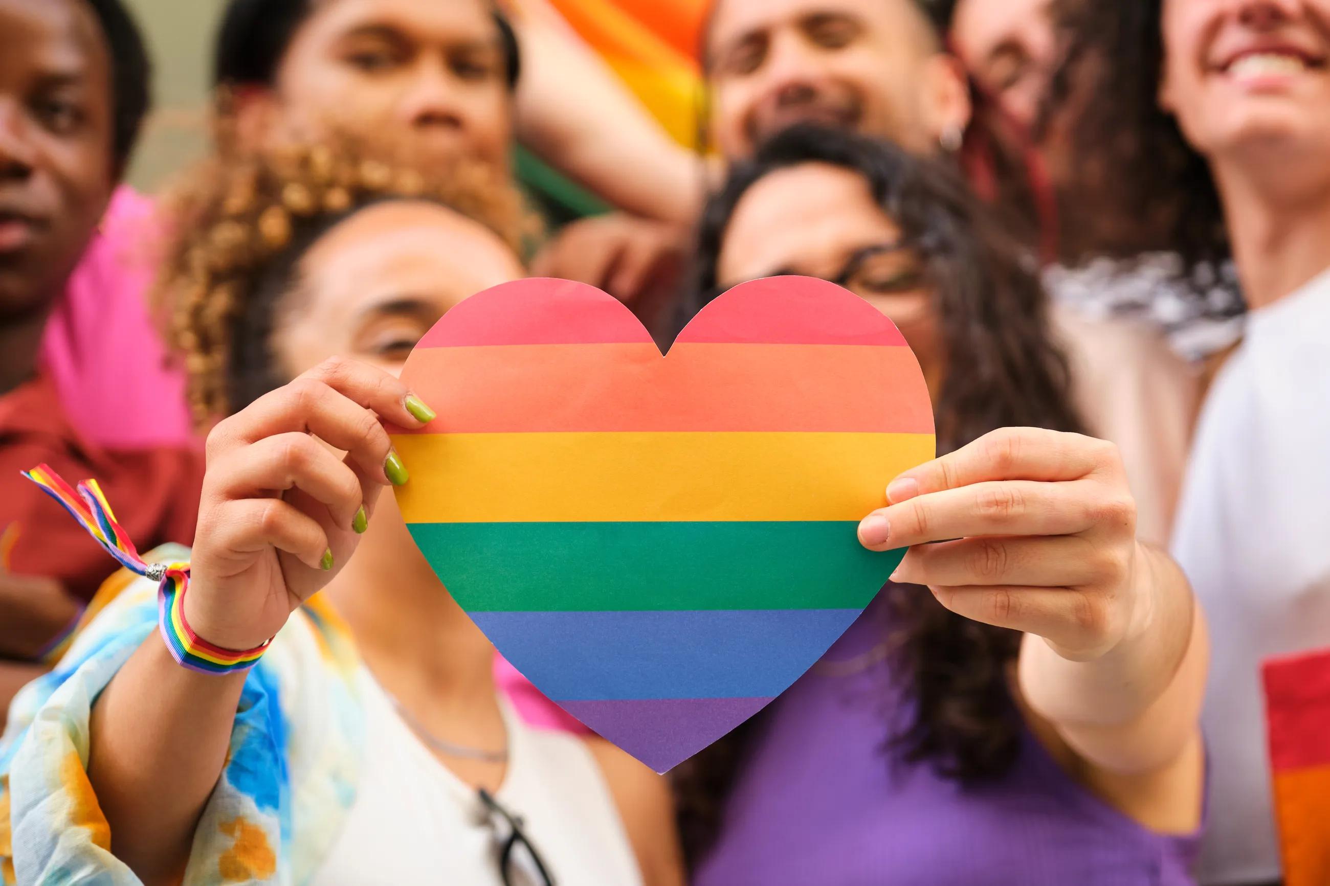 Rainbow heart held by two people celebrating Pride Month - Janus Henderson Investors 