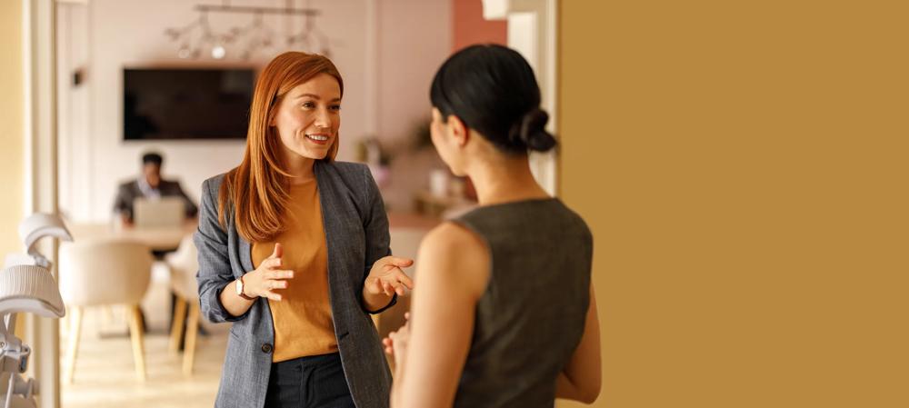 two people having a conversation in an office setting